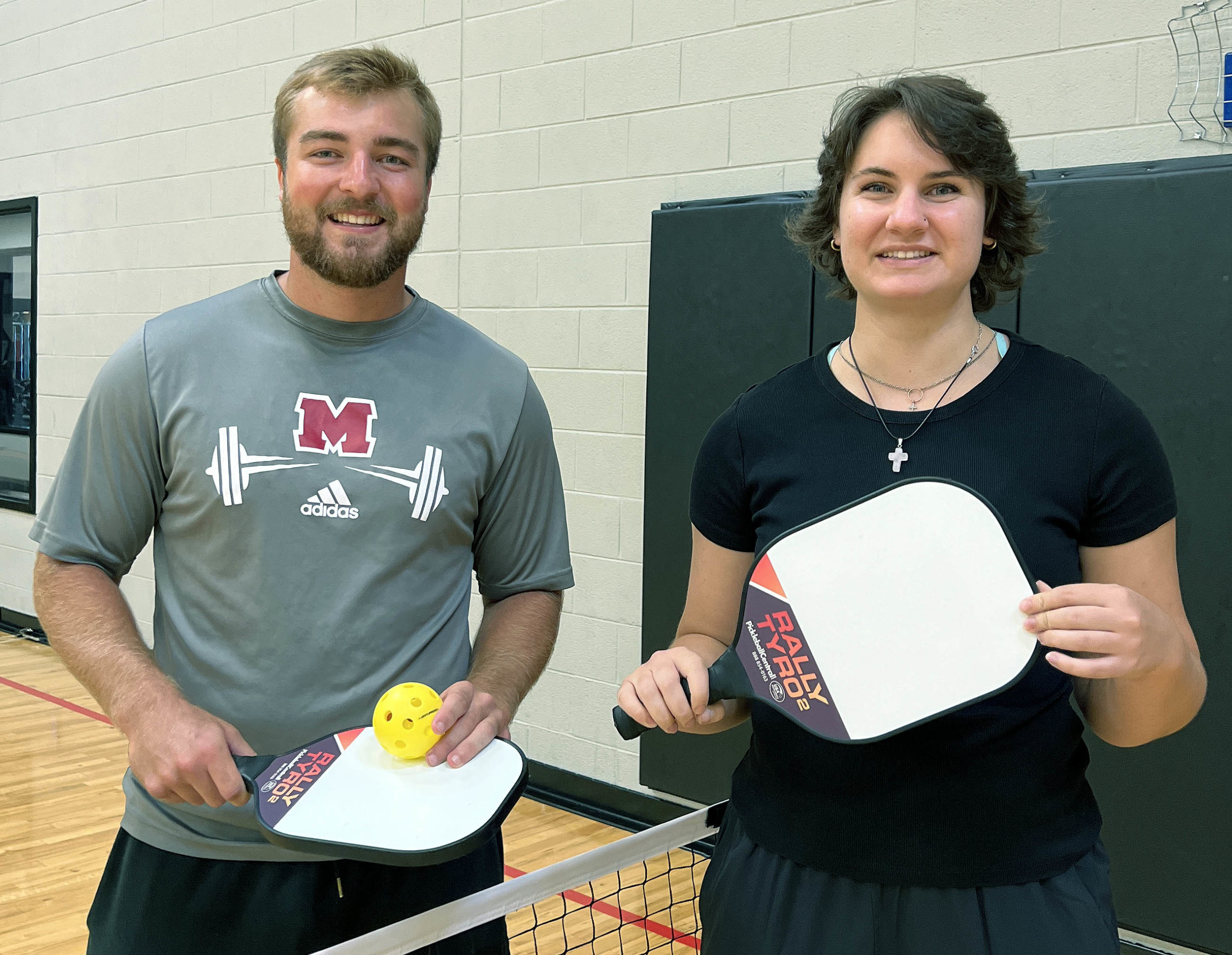 Pickleball Man and Woman holding racquets